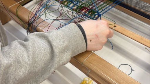 Tying on the Warp (Helena Mardle) picture of someone using a loom