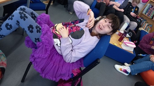 A student dressed all in purple