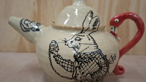 The rabbit from Alice in Wonderland on a teapot. The handle is red and is a flamingo head/neck.