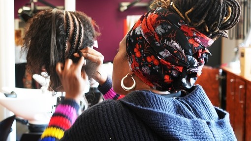 Edwina working on an afro mannequin head/hair