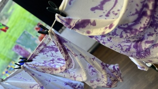 Tie Dye items hanging on an indoor line