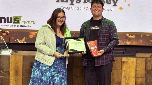 Alys receiving her award from a NUS rep 