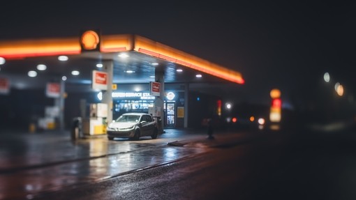 A photographic image of a petrol garage forecourt at night