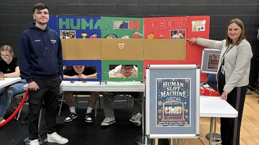 A teacher and a student with the sign 'human slot machine'