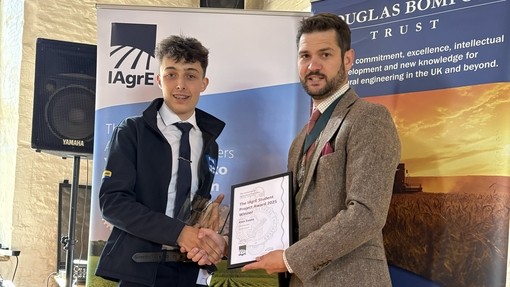 Kien being presented with his award, both are dress in shirt and tie