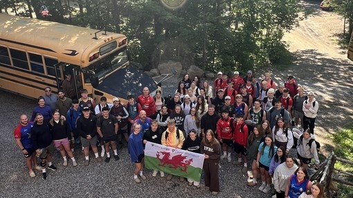 An ariel photo of students outside their yellow bus