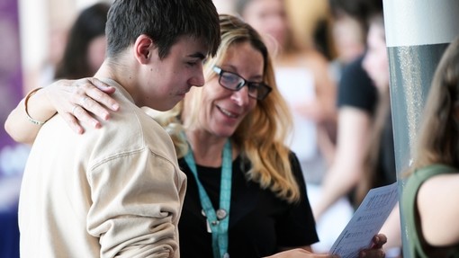 A students looking at their certificate with a member of staff