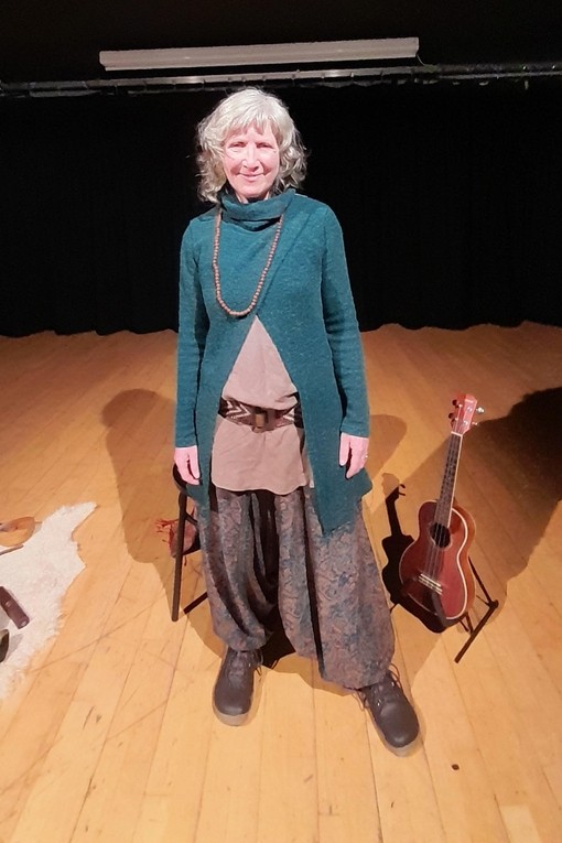 Milly in the performance studio with some sound bowls and an instrument 