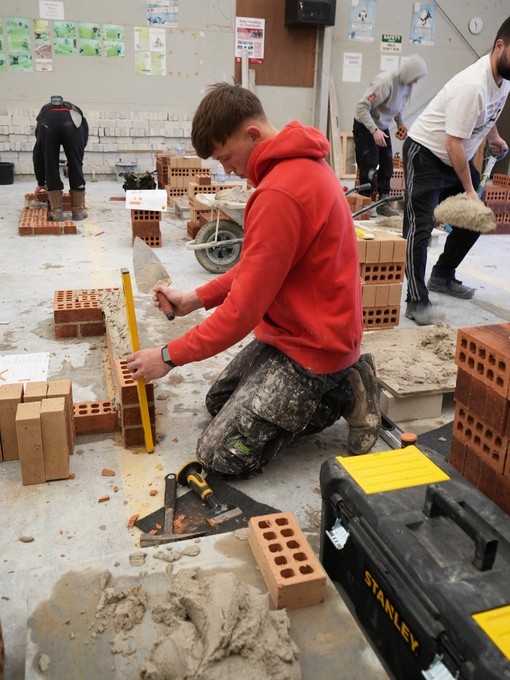 A student working with bricks during the competition