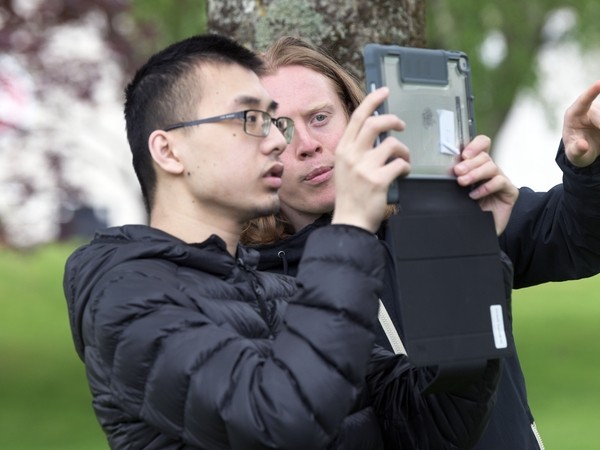 2 boys looking at an ipad