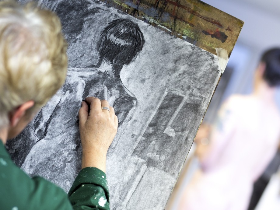 A student works with charcoal.