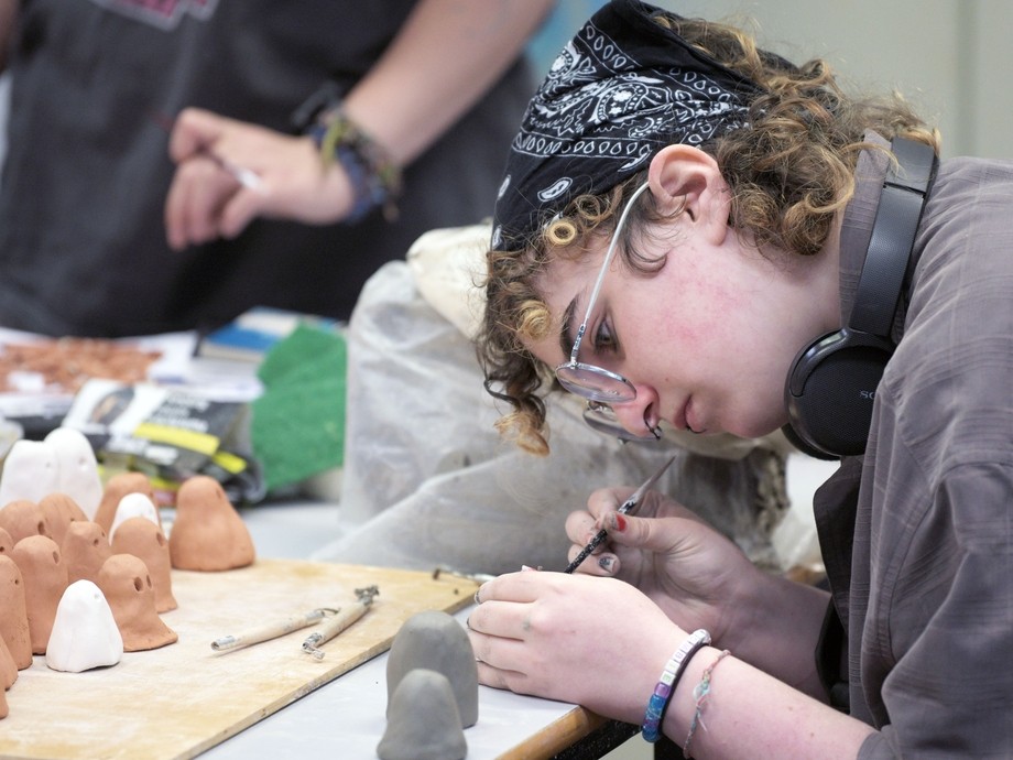 A student works on sculptures. 