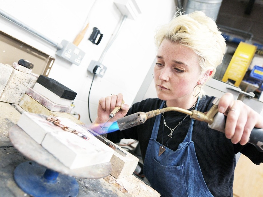 A student uses a blowtorch. 