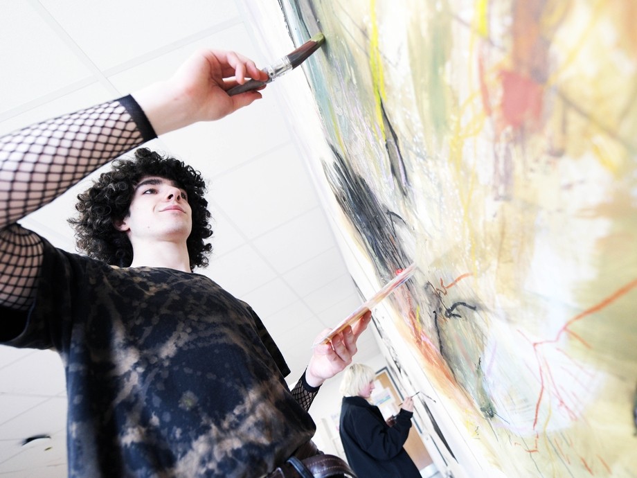 A student paints. 