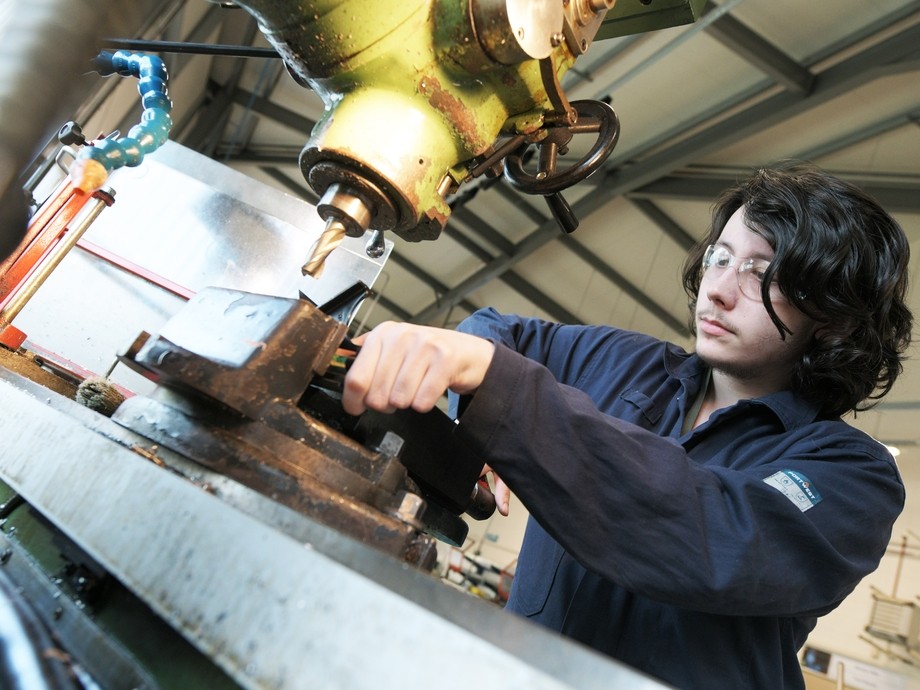 A student using a drill.