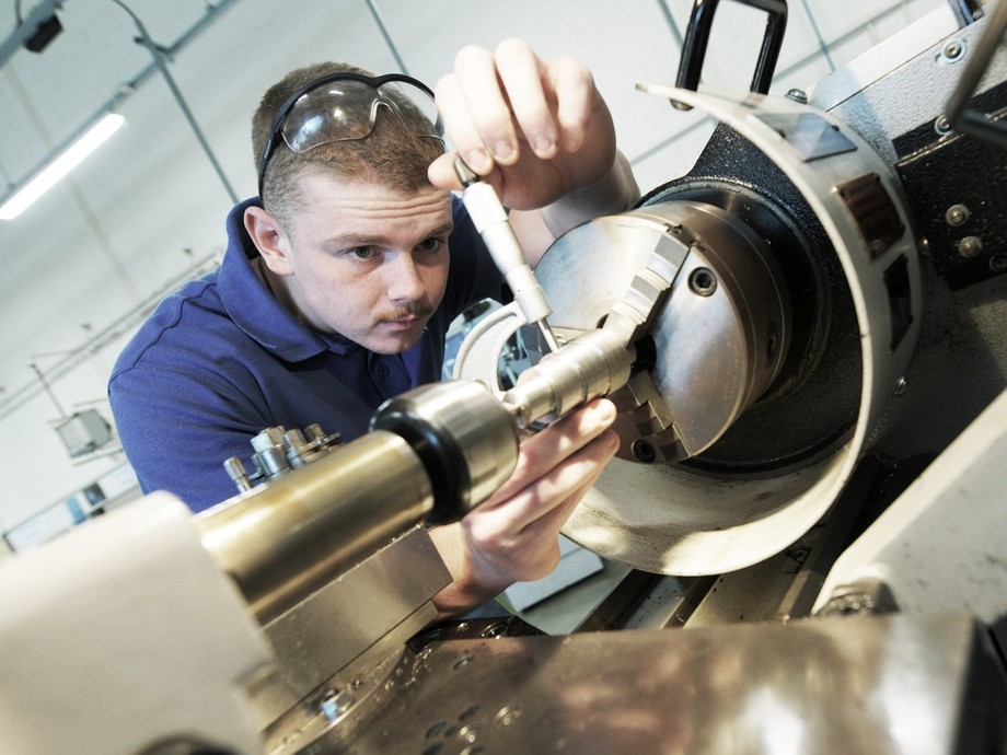 A student using a lathe. 