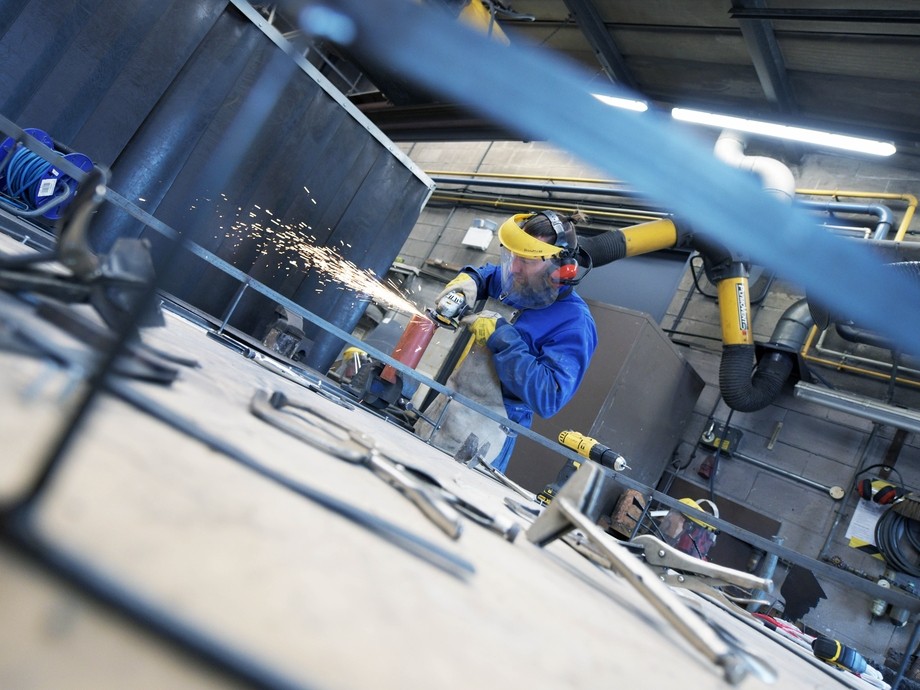 A student uses a grinder. 