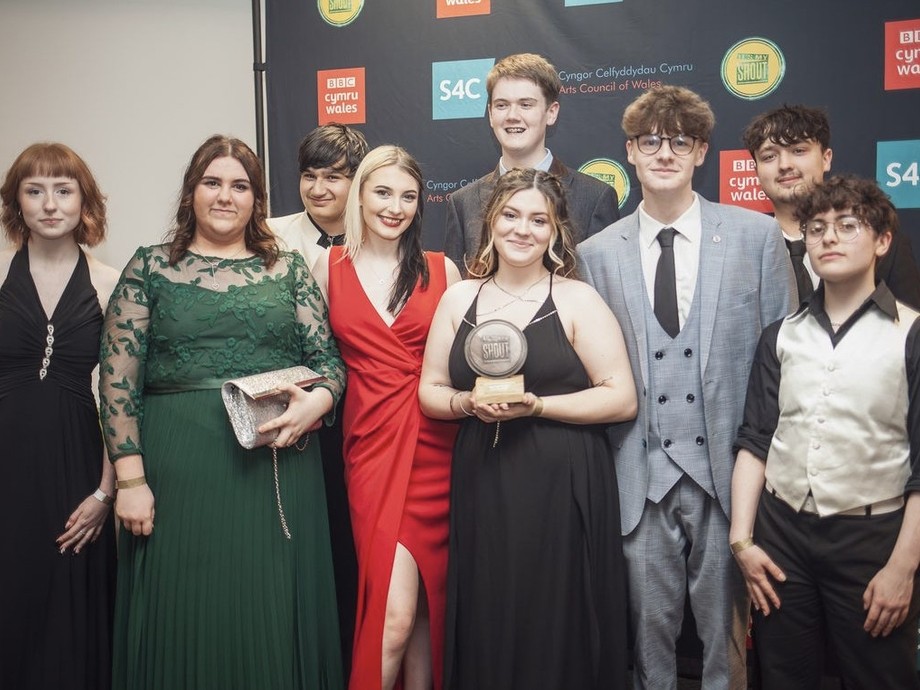group of winner holding award