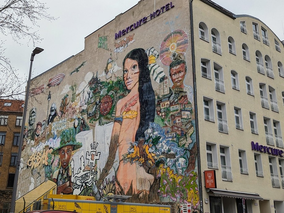 A hotel building with a creative mural down the side