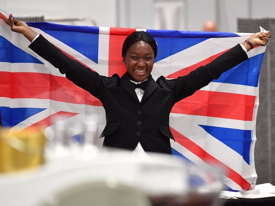 Elizabeth holding up the UK flag 