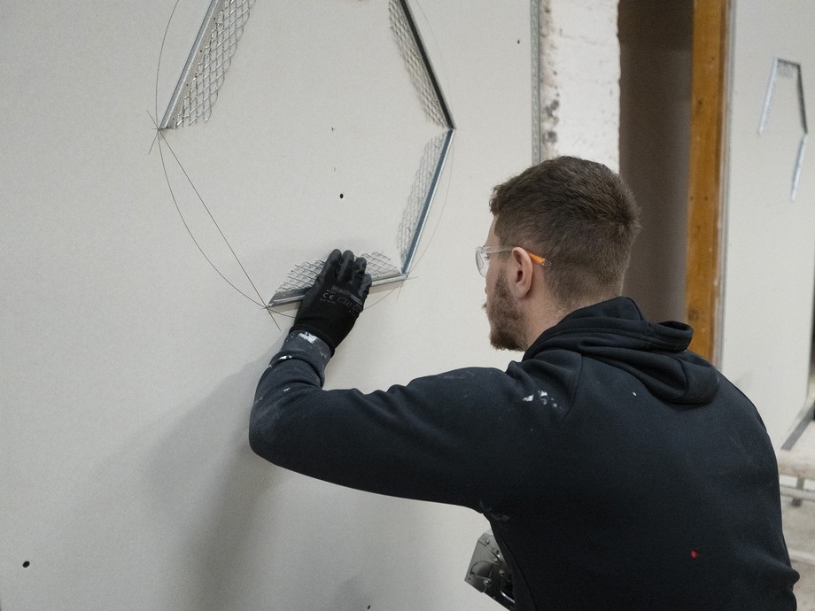 A student plastering