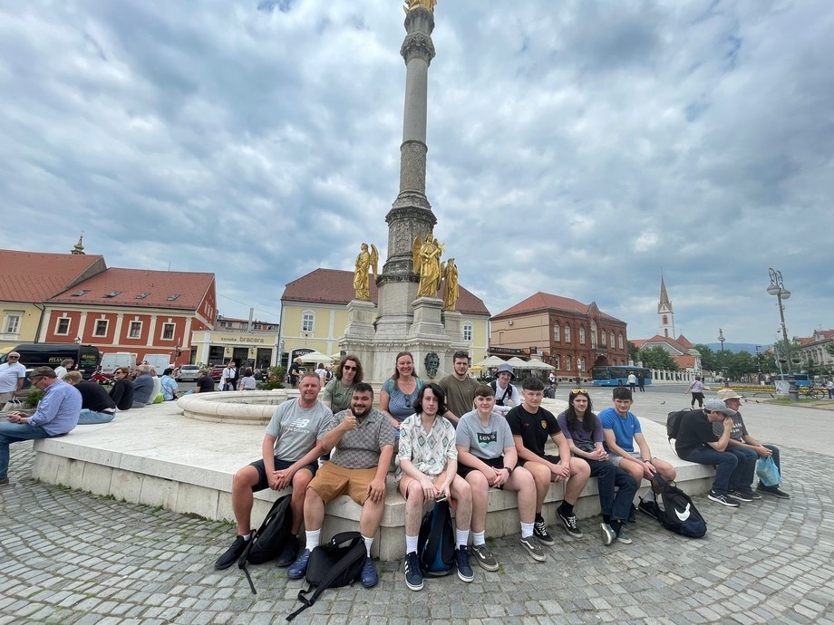 Students gathered around a monument