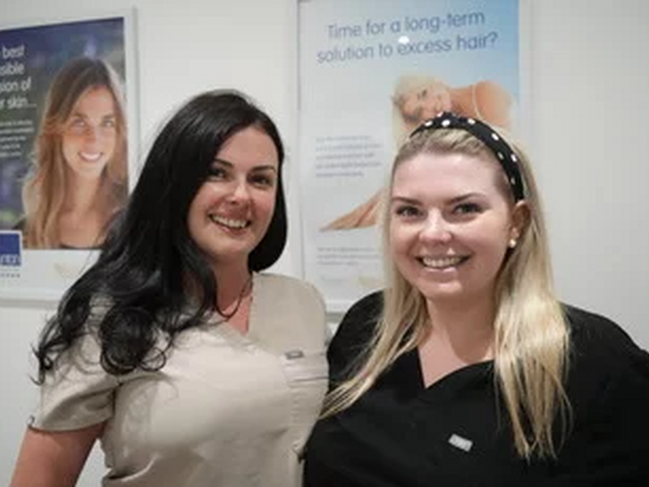 Pictured at her salon with posters in the background