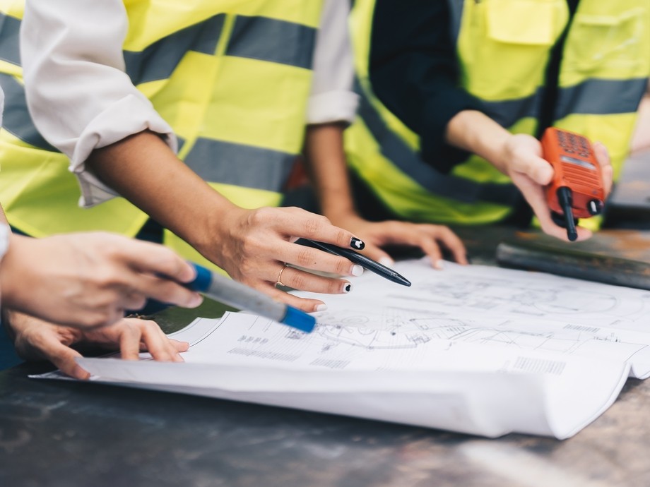 Construction workers looking over paper