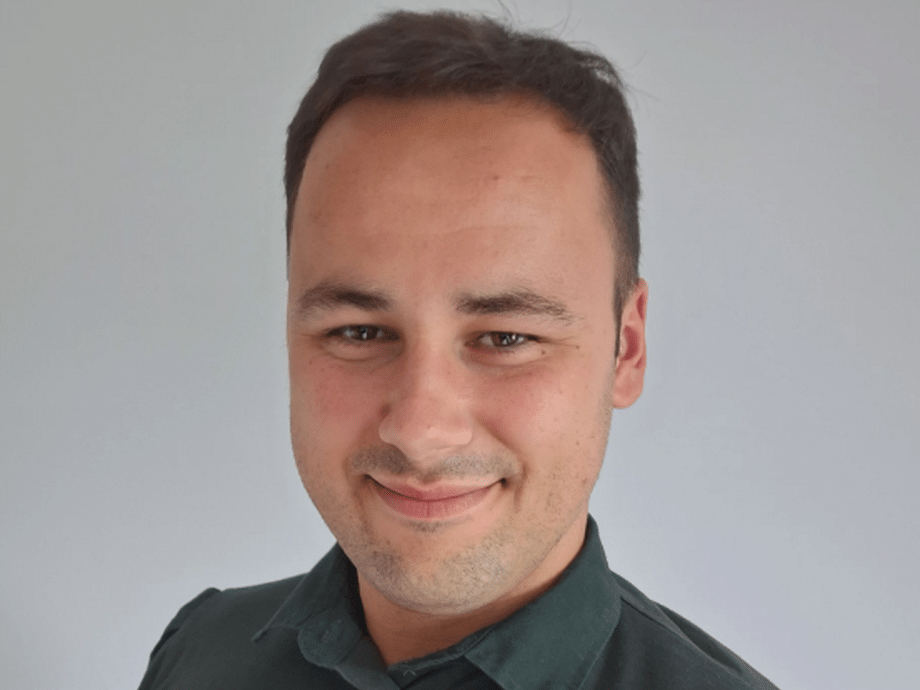 A headshot in his NHS green uniform