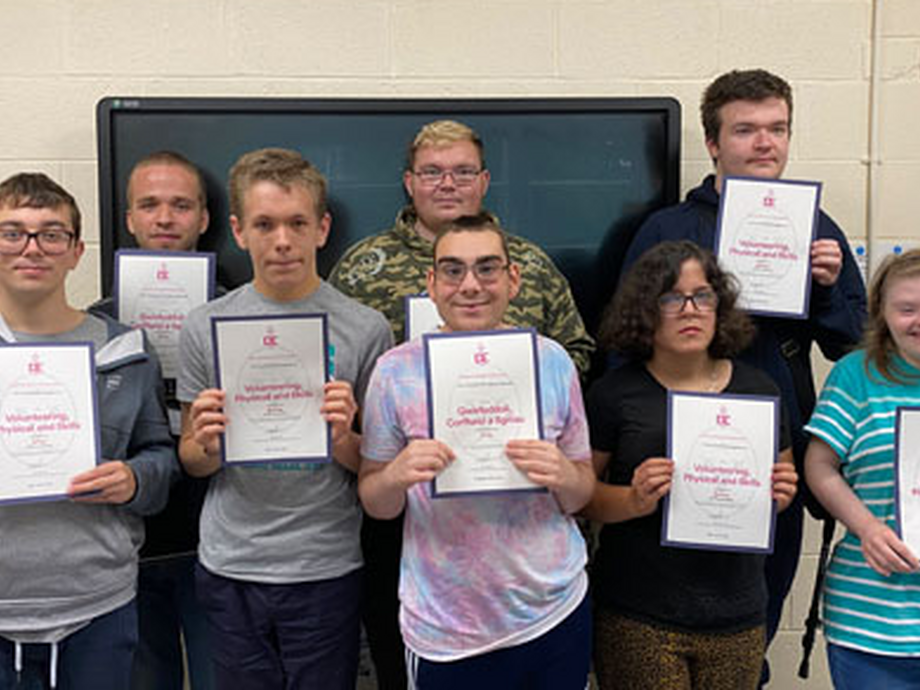 Students in a row with their certificates