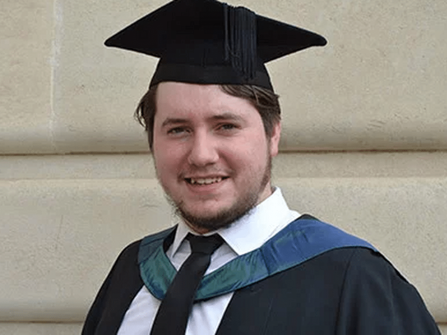 A head shot in a graduate gown and cap