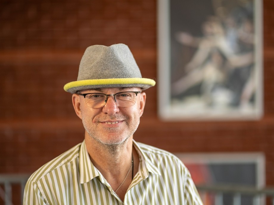 Huw Penallt Jones portrait pic, pictured in a shirt and a hat. 