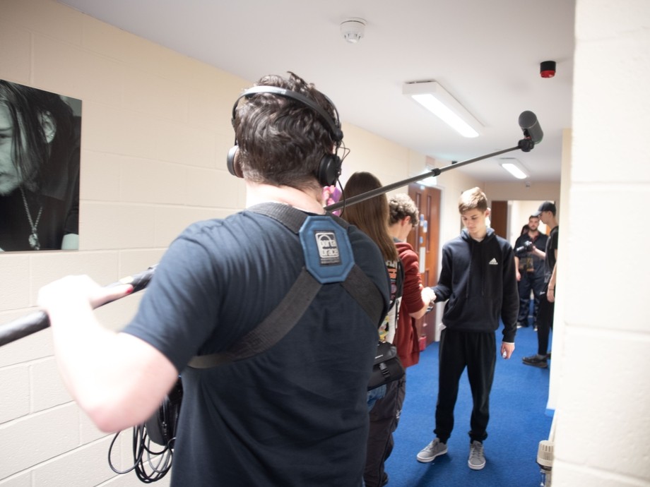 A student holding an extended mic