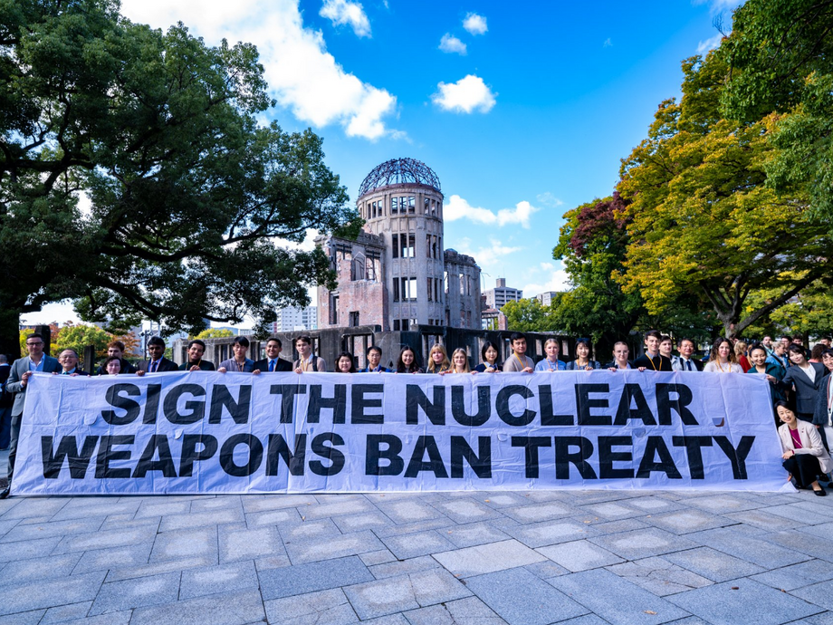 A banner that says sign the nuclear weapons ban treaty