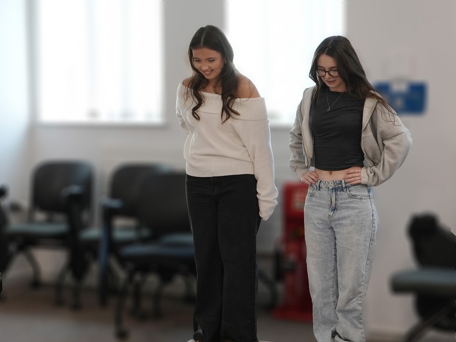 Two girls embarking on a psychology test preparing to walk on a sheet to identify colours and words