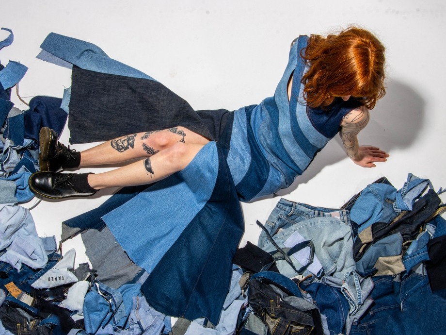 Looking down on a model wearing some materials and clothes which are all blue tones