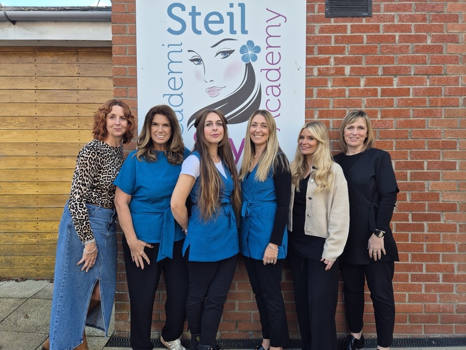 All the team stood outside lined up under the Academi Steil sign