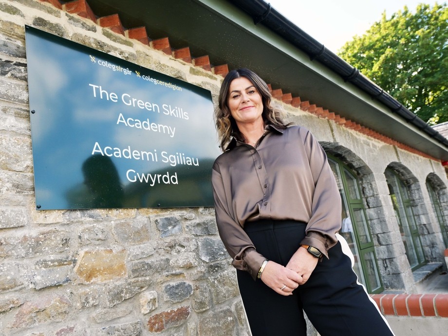 Jemma Parsons standing outside the building by the Green Skills Academy sign