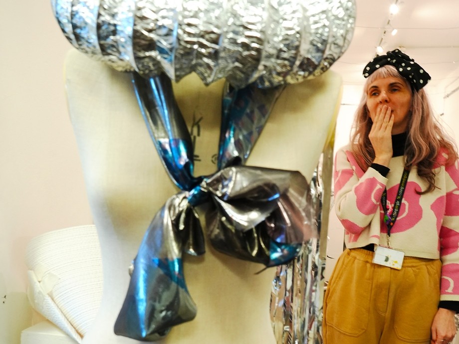 Tutor Katie standing behind a mannequin displaying a foiled-decorated costume