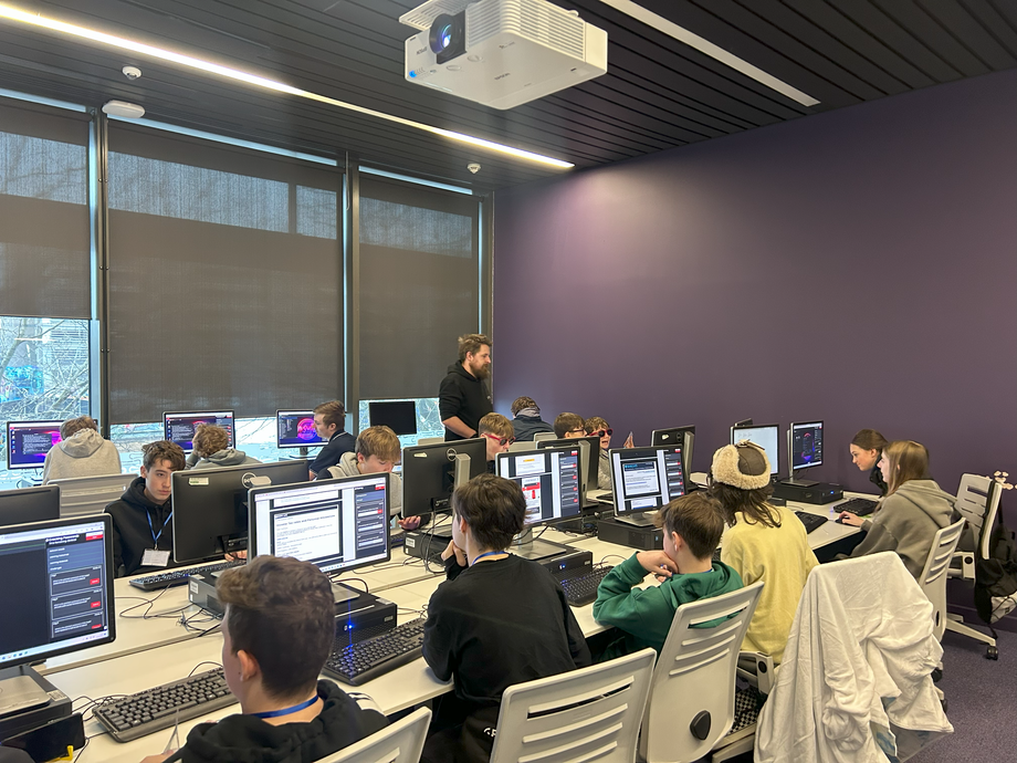 Pupils with computers in a cyber session