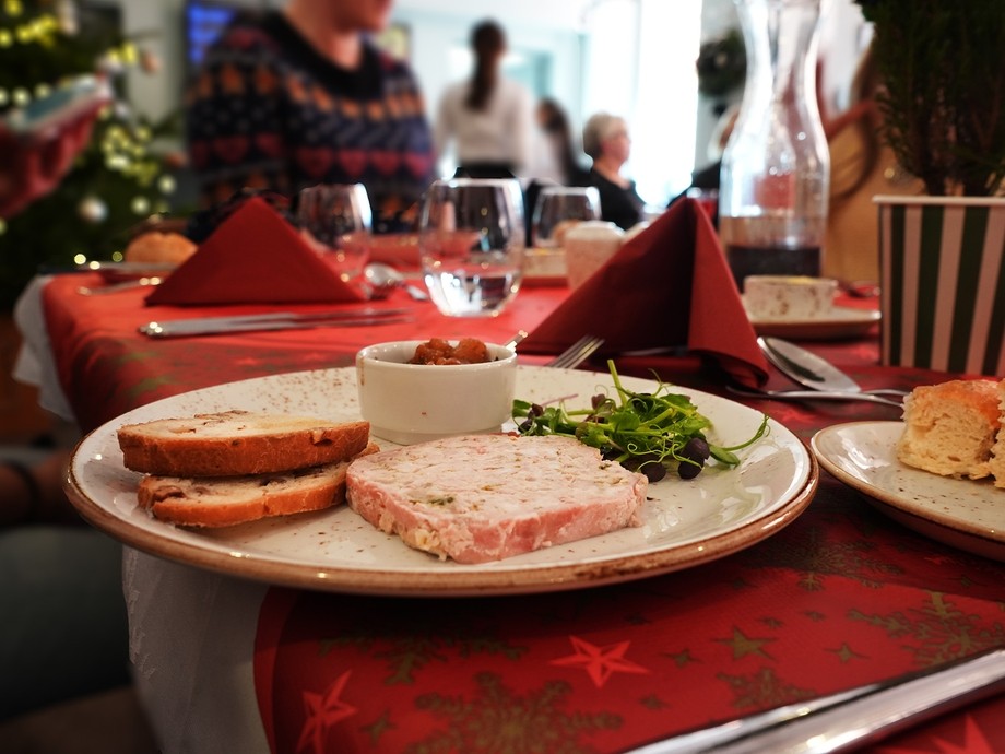 A starter dish of pate on a laid Christmas table