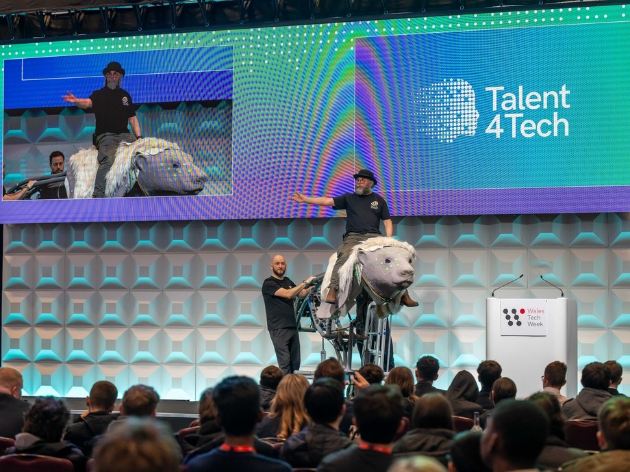A stage with a man on an animatronic talking to an audience