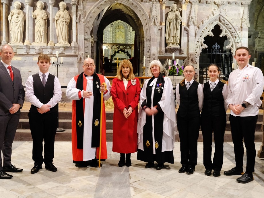 Inside St David's a line of church dignitaries with Sarah Edwards and college students