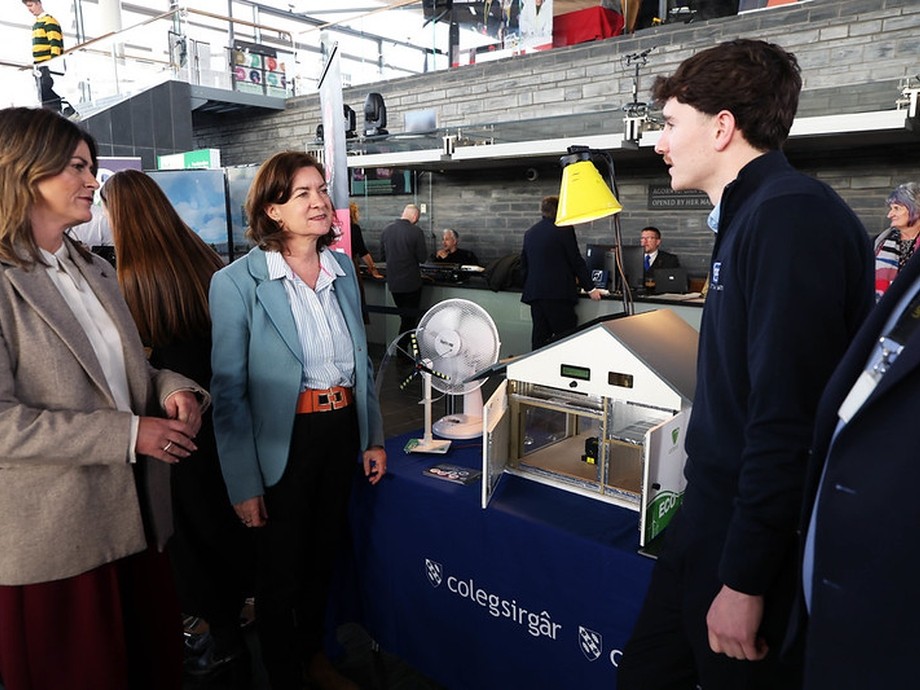 Eluned Morgan talking to apprentice Archi at Senedd event