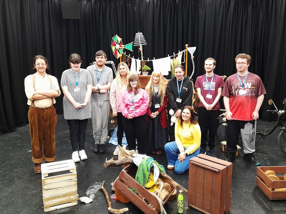 Students on the theatre performance area with the actors and props in the dress rehearsal