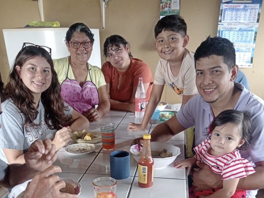Hannah with her Costa Rican family round a table