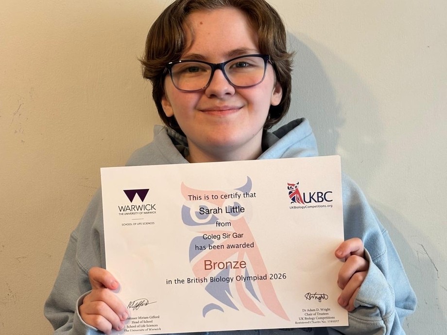Sarah 'Asher' Little holding up her Olympiad bronze certificate