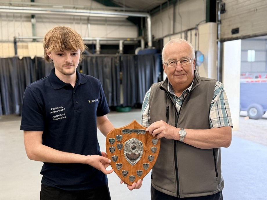 The winner receiving the John Hancock shield