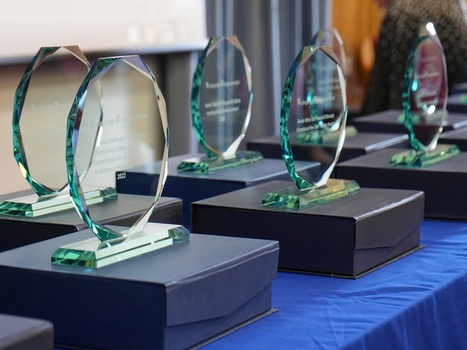 Glass trophies laid out on a table