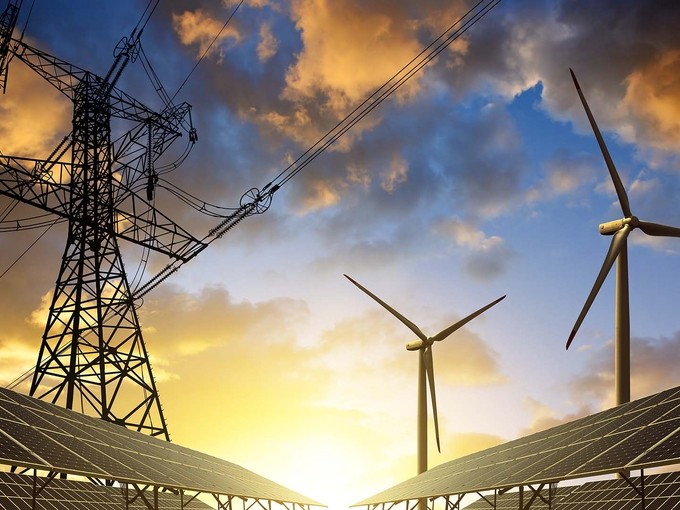 Solar panels and wind turbines during sunrise